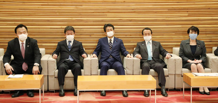 臨時閣議に臨む安倍晋三首相(中央)ら=7日午後、首相官邸