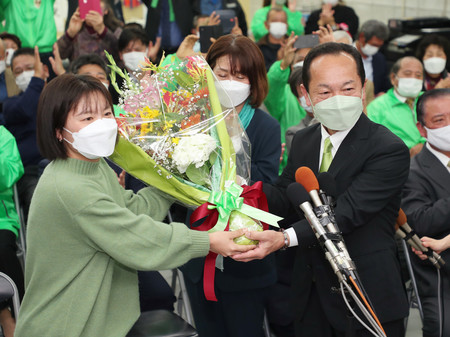 名護市長選挙で勝利し、花束を受け取る渡具知武豊氏(右)=23日午後、沖縄県名護市