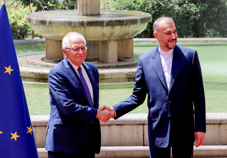 イラン入りした欧州連合(EU)のボレル外交安全保障上級代表(外相、左)を迎えるイランのアブドラヒアン外相=25日、テヘラン(AFP時事)
