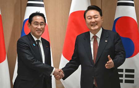 握手する岸田文雄首相（左）と韓国の尹錫悦大統領＝２０２３年５月、ソウル（ＡＦＰ時事）