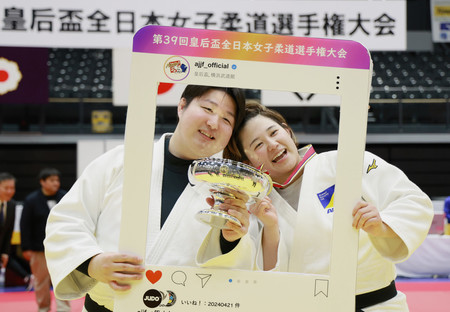 優勝し、夫の勇気さん（左）と笑顔を見せる瀬川麻優＝２１日、横浜武道館