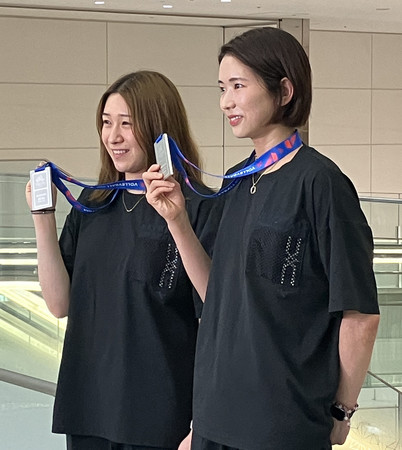 バンコクから帰国し、取材に応じるバレーボール女子日本代表の古賀（右）と石川＝２４日、羽田空港