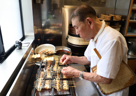 「土用の丑（うし）の日」を迎え、うなぎを焼く遠藤勲さん＝２４日午前、東京都豊島区の「鰻家」