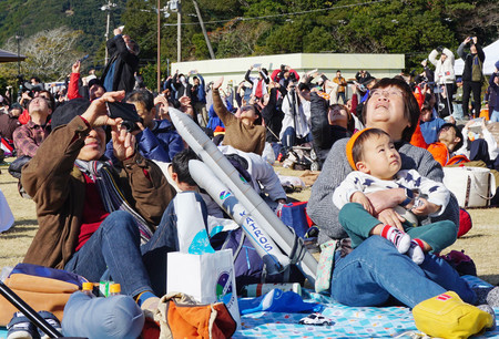 打ち上がった小型ロケット「カイロス」２号機を見上げる見学者ら＝１８日、和歌山県串本町