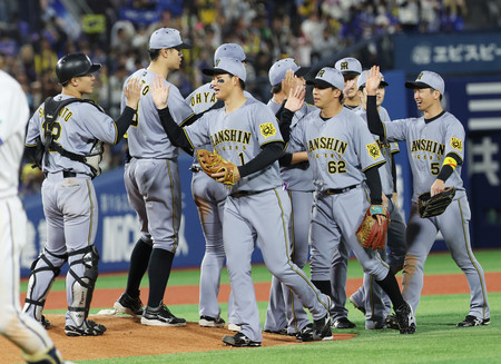 DeNAに勝利し、喜ぶ森下(中央)ら阪神ナイン=24日、横浜