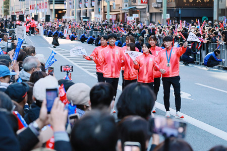 パリ五輪・パラリンピックの応援感謝イベントで、声援に応える近代五種の佐藤大宗（右端）ら日本選手団＝３０日、東京都中央区